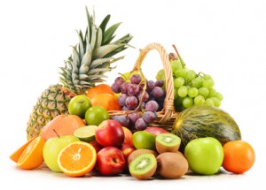 Variety of fruits in wicker basket isolated on white