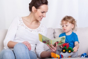 Mother reading book of her son